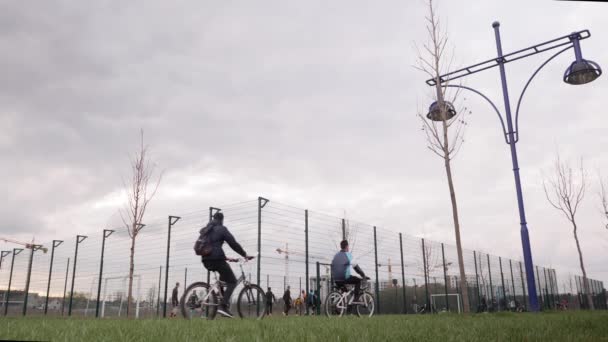 People playing football on modern playground. School student training mini football — Stockvideo