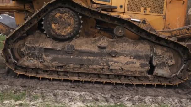 Yellow crawler bulldozer. Earth moving equipment. Caterpillar tractor working — ストック動画