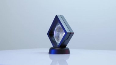 Parlak altın bitcoin dönüyor ve ışığı beyaz arkaplana yansıtıyor