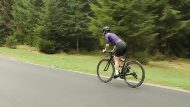 自転車で自転車に乗る。山の中でプロの女性サイクリスト乗馬自転車。トライアスロン — ストック動画