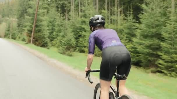 Cycling. Woman cycling. Triathlon hard training. Athlete pedaling out of saddle — Stock Video