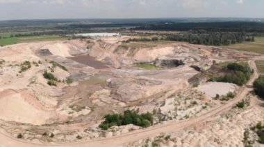 Clay quarry. Excavators and machinery loading sand into dump truck in quarry. Sand mining