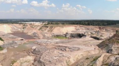 Open pit mining. Iron ore quarry. Large industrial quarry. Excavators and heavy machinery loading ore into dump truck