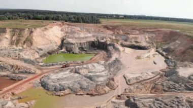 Large copper mine. Iron ore quarry. Open mining. Excavators load ore into dump trucks