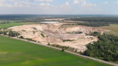 Large clay sand quarry. Iron ore mining quarry. Industrial quarry with mounds of minerals