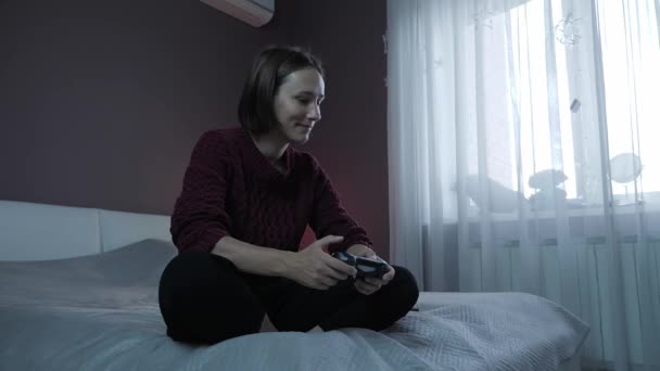 Menina jogando em jogos de vídeo com joystick com controlador sem fio. Actividade de lazer — Vídeo de Stock