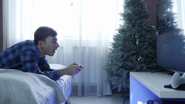 Homem jogando jogo online em casa. Gamer boy usando joystick controlador para jogos de vídeo — Vídeo de Stock