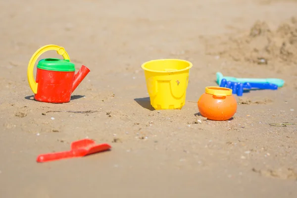 Çocuklar kum oyuncakları sahil kenarında yatıyor — Stok fotoğraf