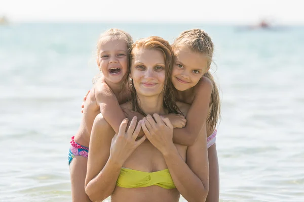 Mother and two daughters swimming in the sea — Stock Photo, Image