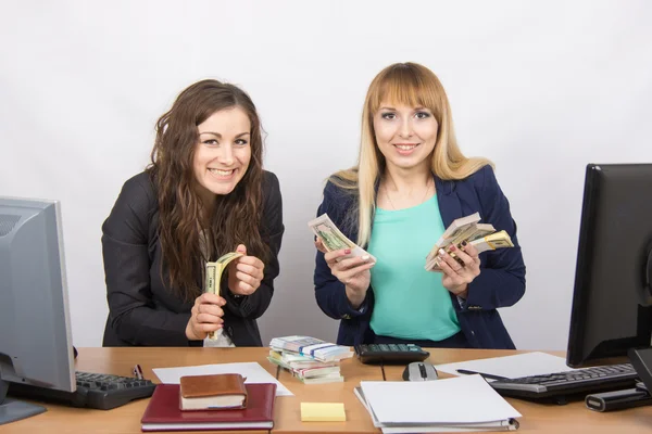 Due molto felice ufficio ragazza felicemente tenendo mazzette di denaro nelle loro mani e guardare nella cornice — Foto Stock