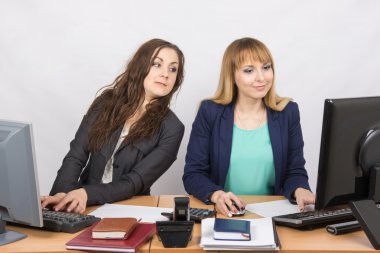 Office worker on the sly looks at the monitor colleague sitting next to a computer clipart