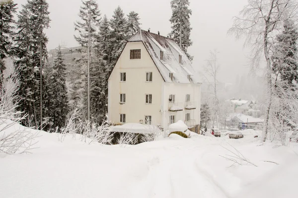 Dombay, Russia - February 7, 2015: The yard facade of the snow-covered hotel "Altair", located in the small town of Dombay — Stock Photo, Image