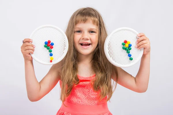 Girl shows colorful flowers collected from the mosaic — Stock Photo, Image