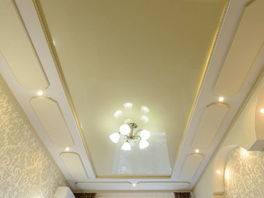 Very beautiful golden ceiling in the interior of the apartment clipart
