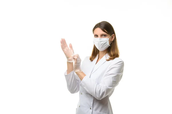 Girl Doctor Puts Transparent Medical Gloves Her Hands Looks Frame — Stock Photo, Image