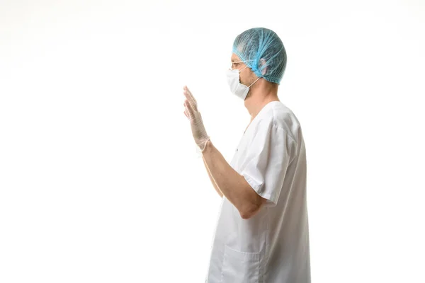 Male Doctor Stands His Hands Raised Gloves Mask Hat His — Stock Photo, Image