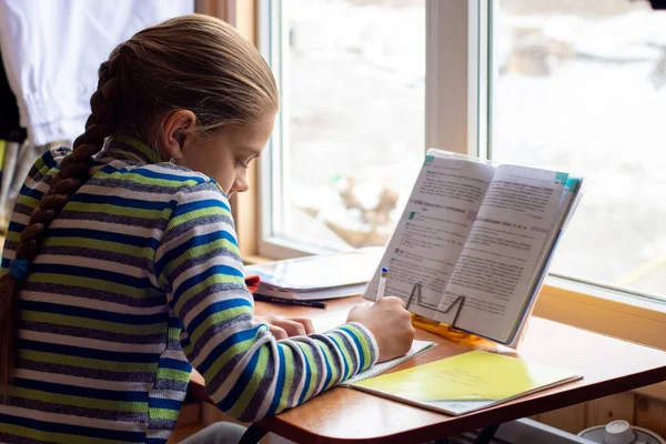 Schoolgirl Sits Table Window Does Homework — Stock Photo, Image