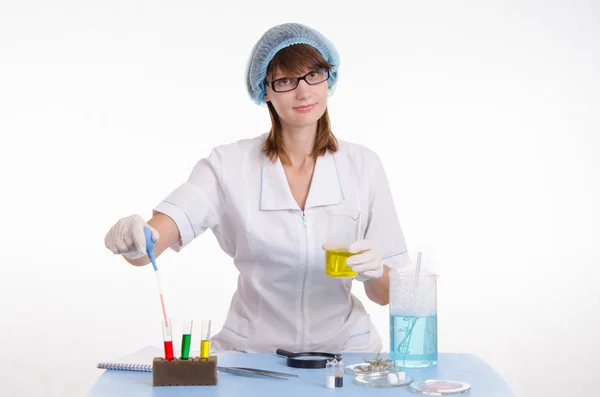 Chemist gaining liquid from a test tube — Stock Photo, Image