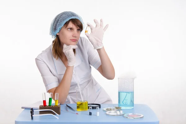 Chemist studying powder in the vial — Stock Photo, Image