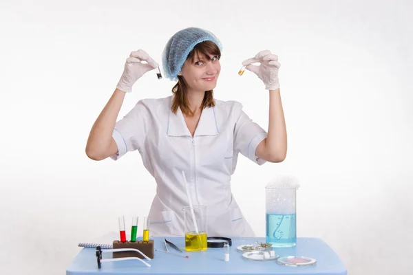 Lab technician with powders in vials Royalty Free Stock Images