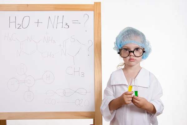 Chemist girl in points and with the tubes at board — Stock Photo, Image