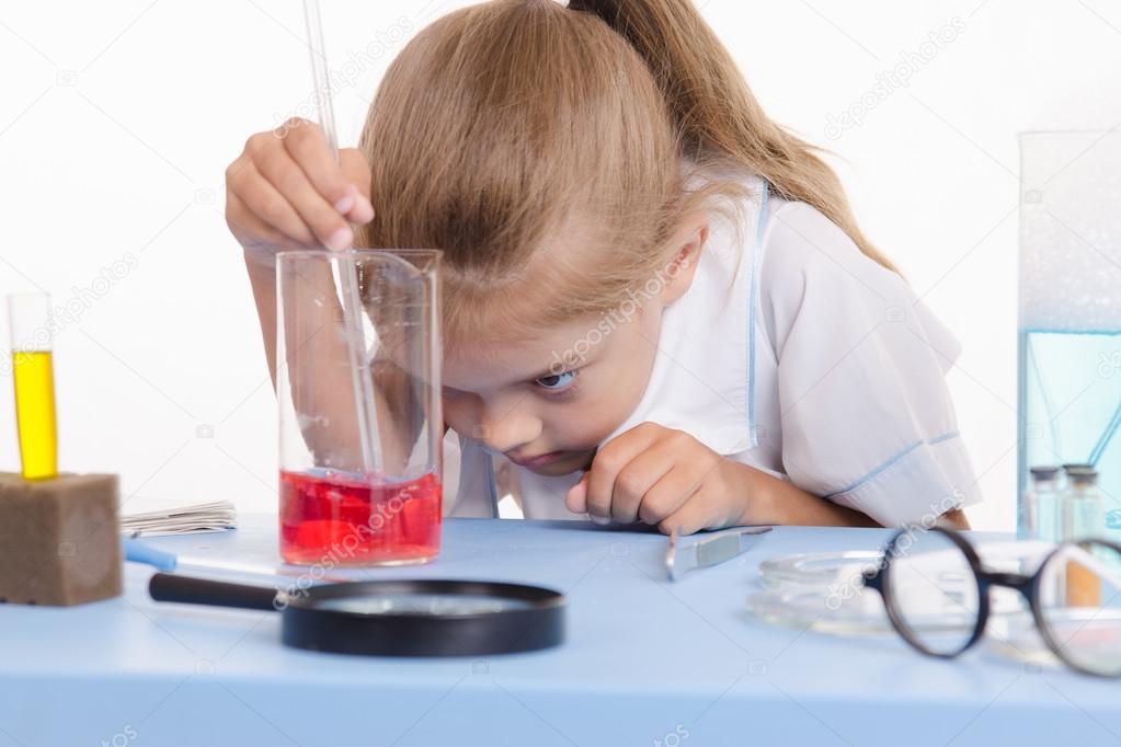 Chemist looking at the liquid in flask