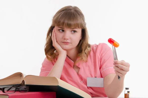 Tired student with a pill — Stock Photo, Image