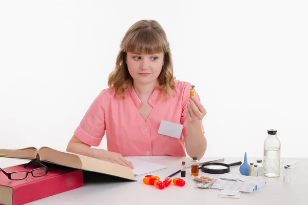 Pharmacist with astonishment looks in the powder — Stock Photo, Image