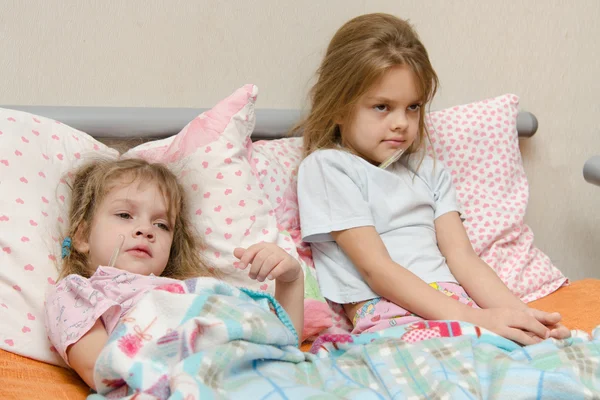 Two girls sick meryat temperature — Stock Photo, Image