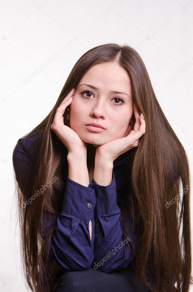 Beautiful girl rests her chin on hand