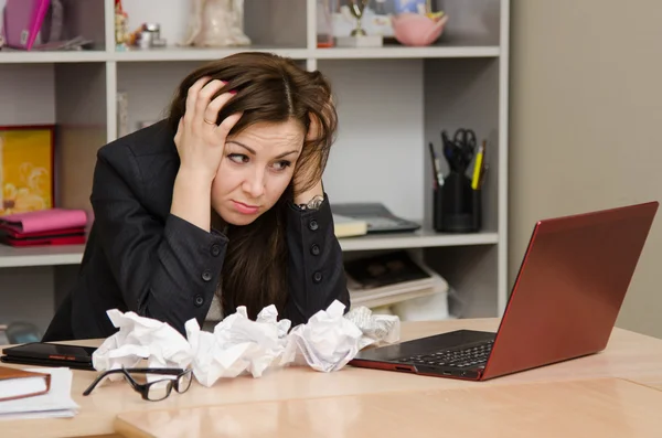 The girl at computer with a bunch of crumpled sheets paper — Stock Photo, Image