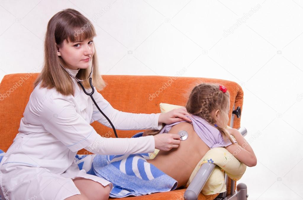 Pediatrician child listens to the lungs stethoscope on her back