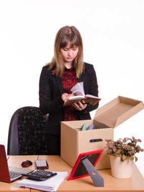 Dismissed girl in office goes through personal belongings clipart