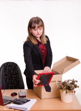 Girl in office collects, parses personal belongings a box clipart