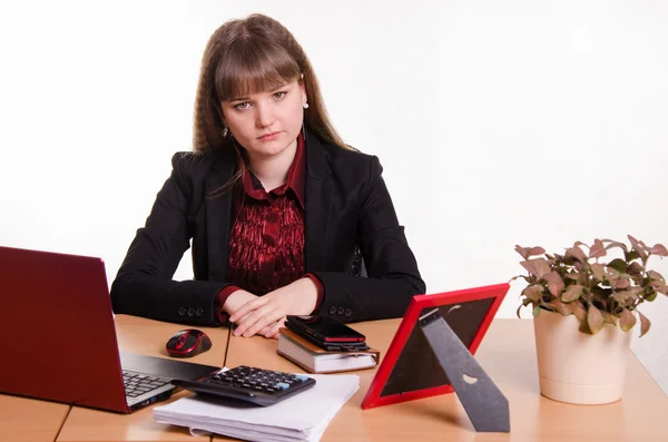 Sad girl sitting at office desk — Stock Photo, Image