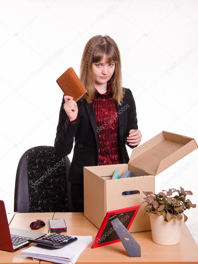 Dismissed girl office throws a notebook in box