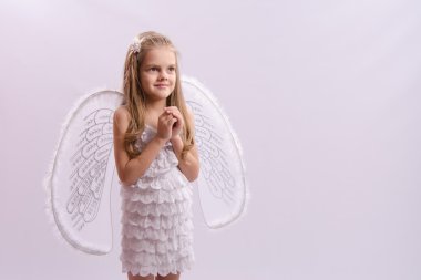 girl dressed as an angel with wings folded hands clipart