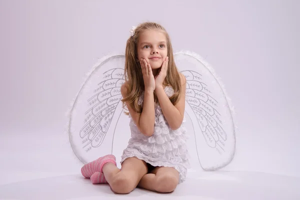 Seated girl with angel wings — Stock Photo, Image