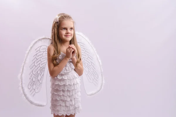 Girl dressed as an angel with wings folded hands — Stock Photo, Image