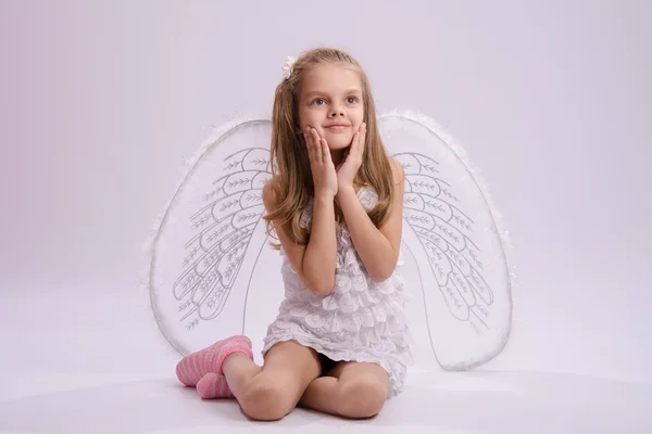 Seated girl with angel wings Royalty Free Stock Photos