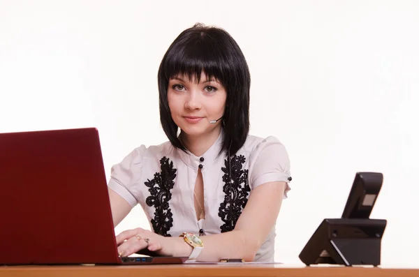 Portrait of a call-center employee in front the monitor — Stock Photo, Image