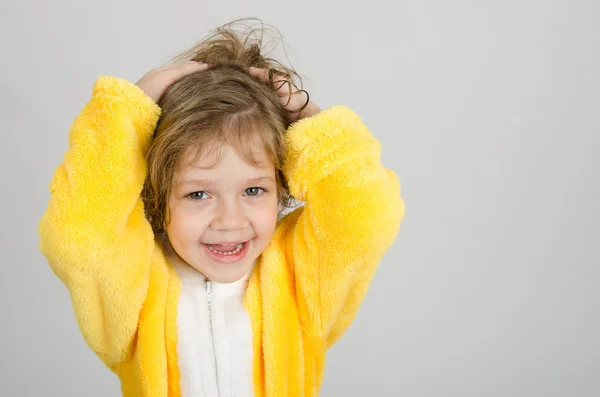 Joyful girl in a yellow bathrobe — Stock Photo, Image