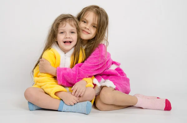 Two girls sit in robes — Stock Photo, Image