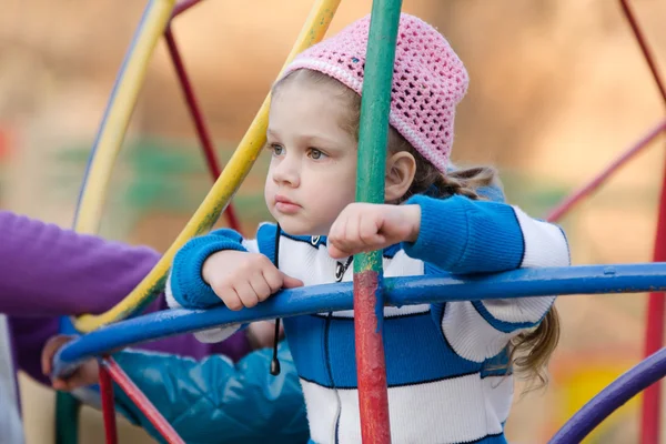 Four-year girl thought playing on the playground — Stock Photo, Image