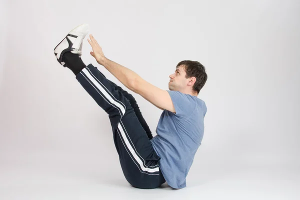 Athlete stretching his arms raised to the feet — Stock Photo, Image