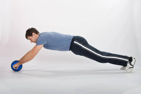 Athletes perform push-ups using the wheel — Stock Photo, Image