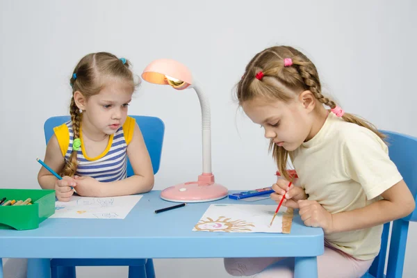 Menina assistindo irmã desenha pinturas — Fotografia de Stock