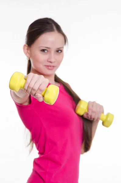 Sportswoman with two dumbbells in the hands of — Stock Photo, Image