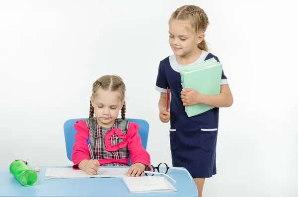 Girl teacher during task checks correctness of its implementation — Stock Photo, Image