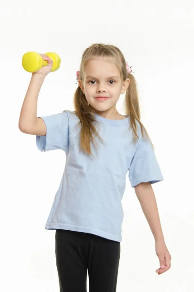 The girl raised her right arm dumbbell — Stockfoto